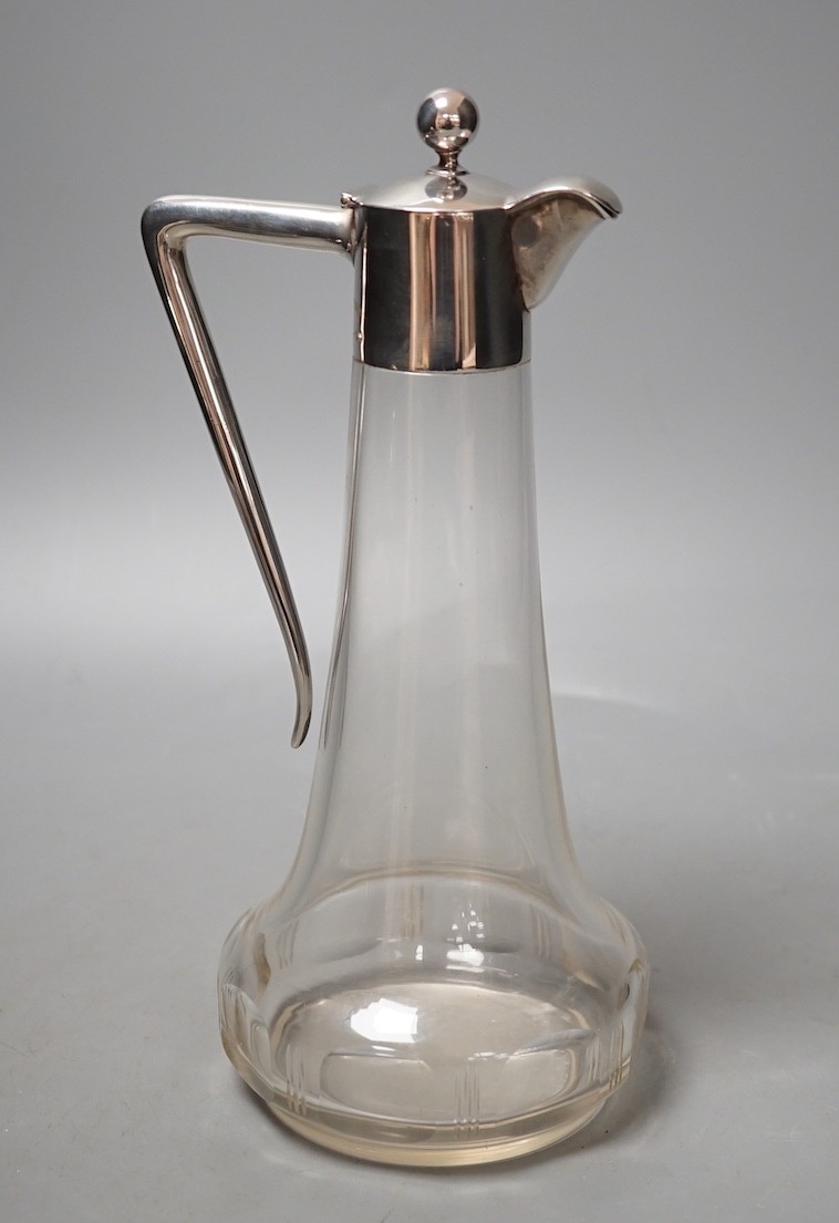 A German white metal mounted glass liqueur jug, 24.6cm.